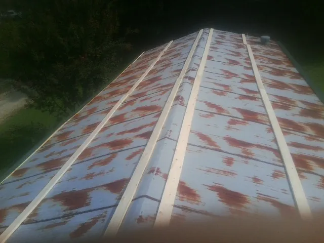 Rusted metal roof panels with new wood purlins before replacement — Storm Damage Roof Repair in Whitesboro by Roofing Brothers